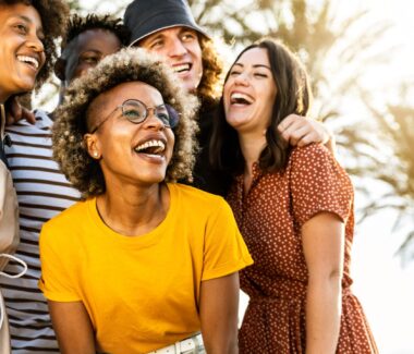 Group of multi-racial friends laughing and enjoying themselves.